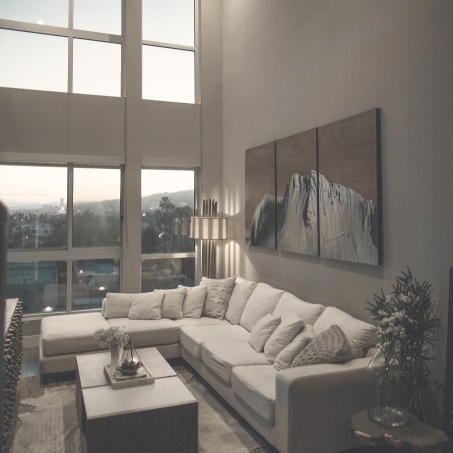 Calm and balanced double-height living room in a Gurgaon home