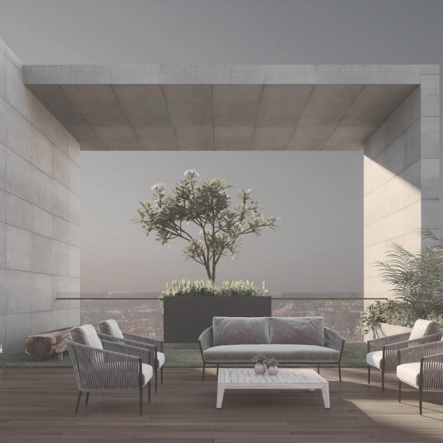 Board-marked concrete loggia framing the Gurgaon skyline at dusk
