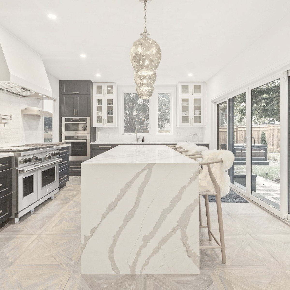 Modular kitchen with a marble waterfall island, planned for an Indian home