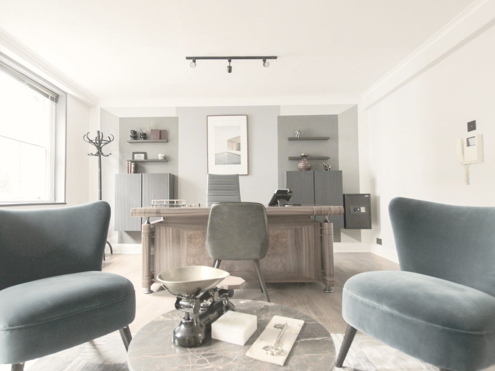 Private office cabin designed in Gurgaon, with a walnut desk and velvet lounge chairs